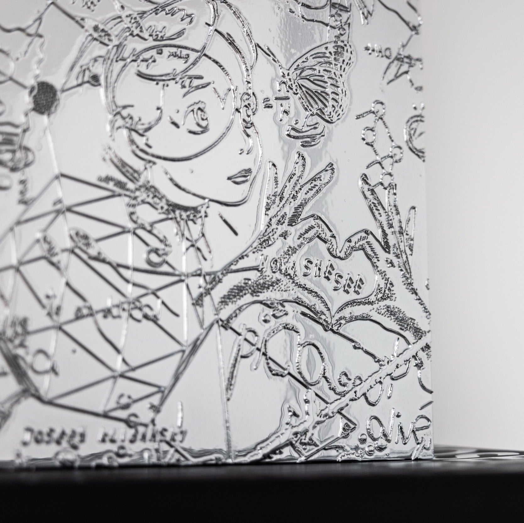 A detail close up of a chrome painting collectable art collectable by Joseph Klibansky
