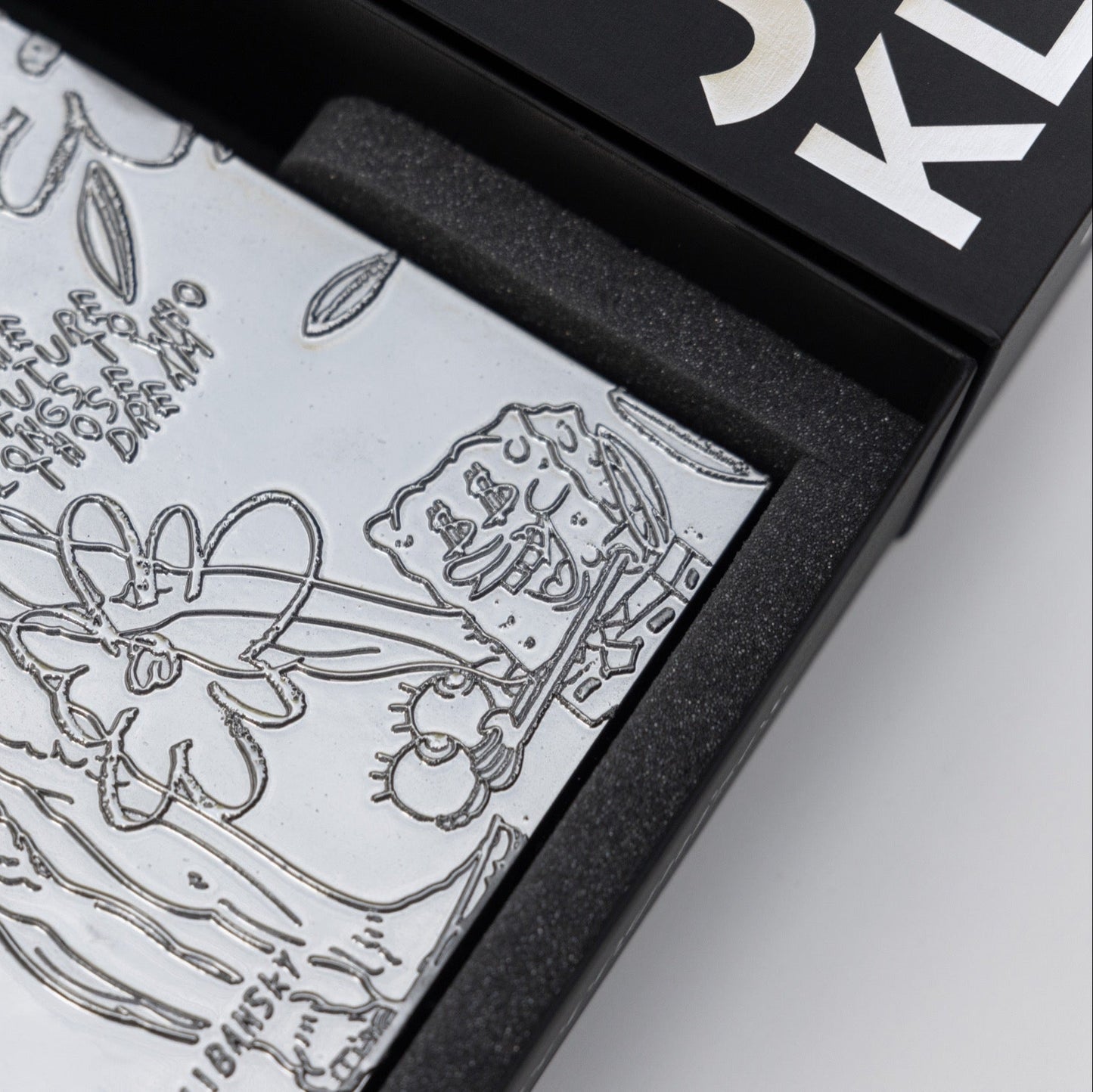 Close-up of chrome painting collectible by Joseph Klibansky in collector's box